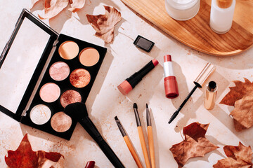 Autumn skincare and autumn makeup concept with beauty products on table