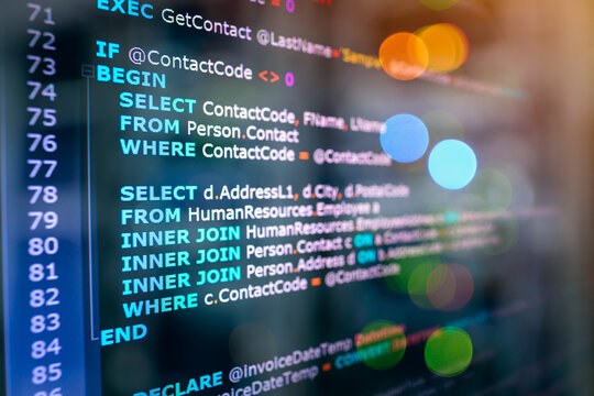 SQL (Structured Query Language) code on computer monitor and server room background. Example of SQL code to query data from a database.