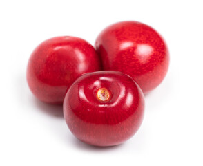 Three sweet cherries isolated on a white background.