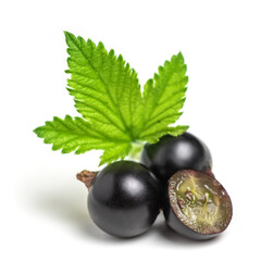 Group of black currants with leaves, one sliced in half