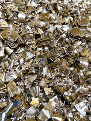 Brass scrap turnings a waste from a factory. Portrait view.