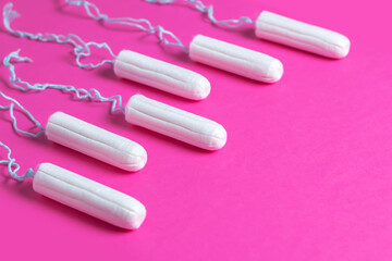 Menstrual period concept. Woman hygiene protection. Cotton tampons on pink background.