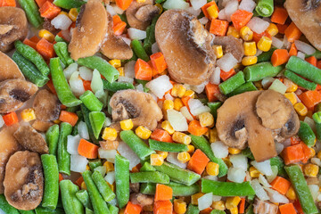 Chopped frozen vegetables background. Corn peas pepper carrots