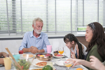 Happy multiracial family having dinner party In Kitchen Together - Group of friends dining at garden restaurant - Young people enjoying lunch break together - Food and beverage lifestyle concept. 
