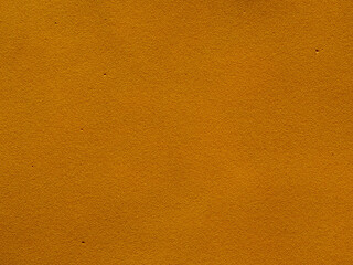 Bright mustard-colored background. The background texture is dark orange. Surface of decorative fine-grained foam rubber