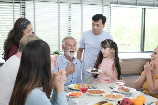 Happy multiracial family having dinner party In Kitchen Together - Group of friends dining at garden restaurant - Young people enjoying lunch break together - Food and beverage lifestyle concept.