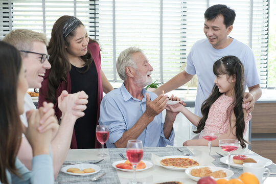 Happy multiracial family having dinner party In Kitchen Together - Group of friends dining at garden restaurant - Young people enjoying lunch break together - Food and beverage lifestyle concept.
