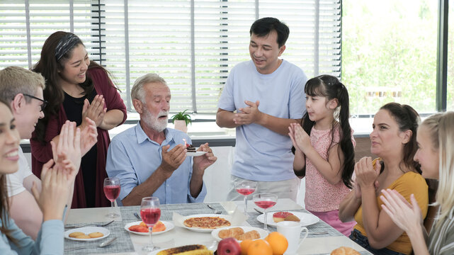 Happy multiracial family having dinner party In Kitchen Together - Group of friends dining at garden restaurant - Young people enjoying lunch break together - Food and beverage lifestyle concept.