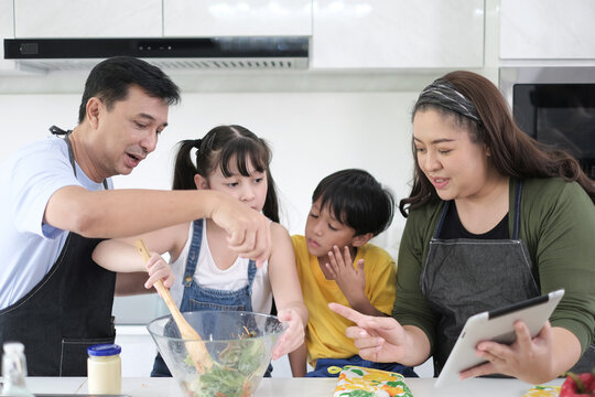 Happy multiracial family having dinner party In Kitchen Together - Group of friends dining at garden restaurant - Young people enjoying lunch break together - Food and beverage lifestyle concept.