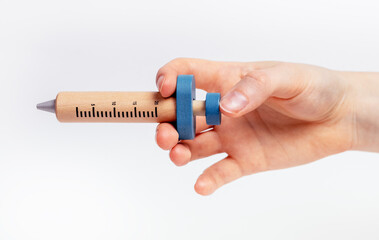 Wood kids syringe toy in female hand closeup, injection. High quality photo