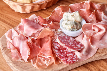 Wooden cutting board with various Italian salami, chorizo, sausages. Antipasti appetiser