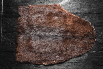 Animal fur on the wooden table background. Top view.