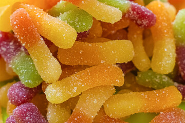 multicolored candy gummy worms close-up background confectionery