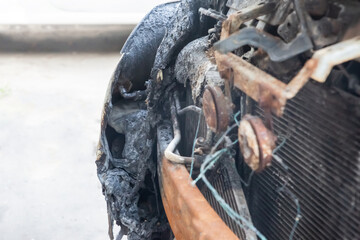 front of the car after an accident on the road, melted bumper after a fire