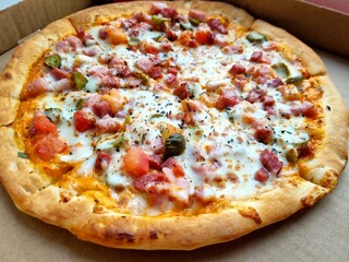 pizza with sausage, vegetables and cheese