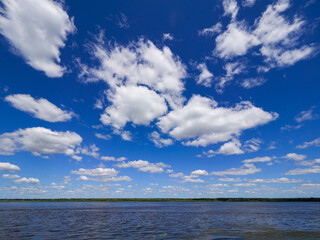 Naklejka na ściany i meble waves on the sea landscape on a background of blue sky with clouds