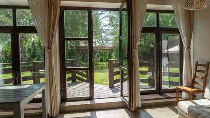View of garden from inside house with french doors leading to a courtyard garden. View through the window on garden.