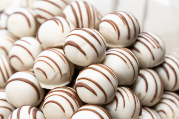 slide of chocolates covered with white chocolate and lines from brown close-up