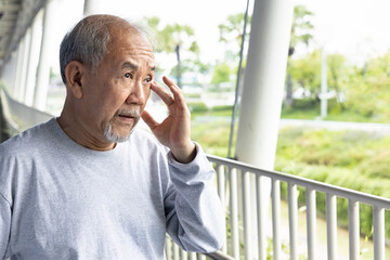 Old senior man having eyesight problem or dry eye symptoms