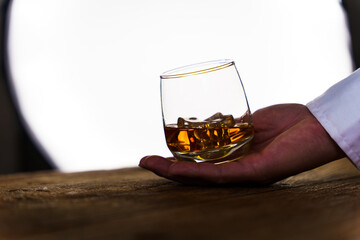Barman pouring wiskey whiskey glass and giving.