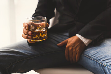 Alcoholism concept. Young man drinking alcohol too much. Alcoholic with a glass of whiskey,...