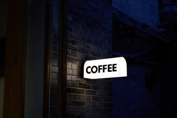Close-up of light box in cafe in alley at night