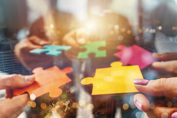 Teamwork of partners connect puzzle pieces as integration and startup