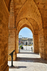 Fototapeta na wymiar The arches of a portico leading to the town square of Uggiano, a medieval village in the Puglia region of Italy.