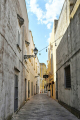 A narrow street between the old houses of Uggiano, a medieval town in the Puglia region of Italy.