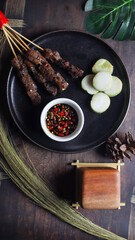 chiken satay with rice cake and spicy soy sauce that is delicious to eat in depok, West Java on July, 2022