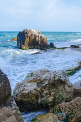 Turquoise shallow water surface and rocks stones on sea floor.