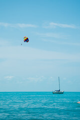 Rainbow parachute on the background of the blue sea and sky. Landscape. Summer. Vacation.