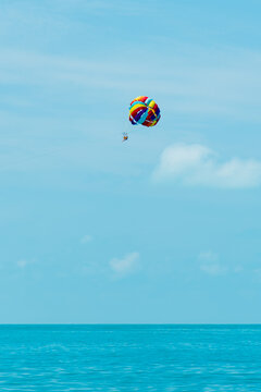 Rainbow parachute on the background of the blue sea and sky. Landscape. Summer. Vacation.