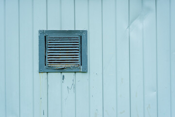 The texture of a white metal wall with a ventilation grate - 514817569
