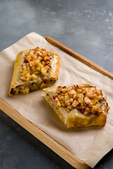 Apple strudel on wooden board on grey table vertical
