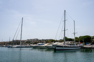 Fototapeta na wymiar Sleek and modern sailboats and motor boats in a central marina in Antibes, France. Yachts and speed boats in the port.