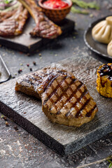 medallions of beef on wooden board side view, vertical