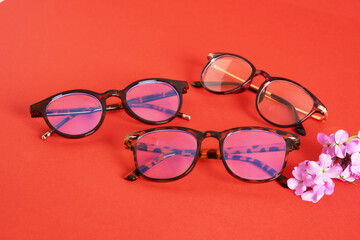 trandy eye glasses on bright red background