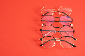 trandy eye glasses on bright red background