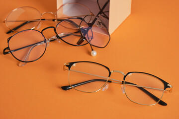 eye glasses on gift box orange background copy space