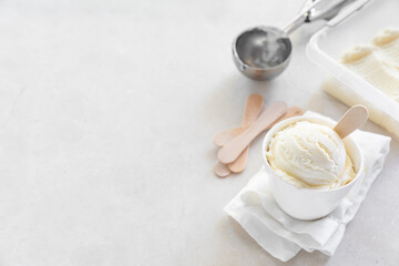 Vanilla ice cream in white cup, marble background