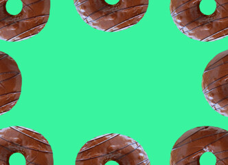 Frame of Chocolate Glazed Donuts on Mint Green Background