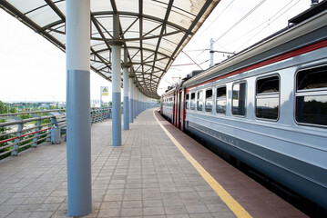 a railway platform with train in summer
