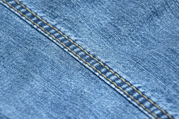 Fototapeta premium Lots of jeans pants in a stack. Denim background.