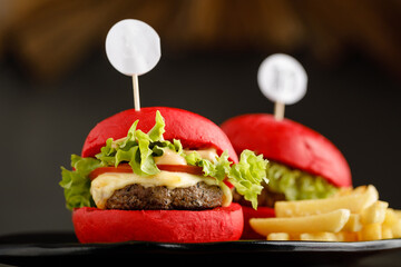 Mini Beef Burger with fries served in a dish isolated on grey background side view fast food