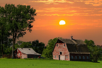 A weathered red barn in a farm in north eastern North Dakota. © Bob