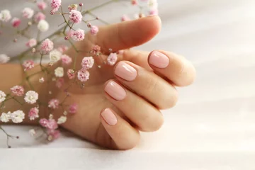 Foto op Plexiglas Light pink manicure on short nails with Gypsophila. © marigo