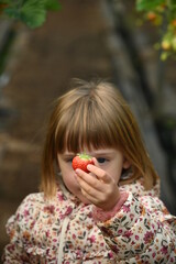 Girl holding fresh strawberry