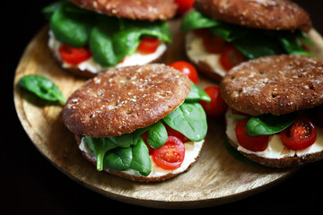 Healthy sandwiches with spinach, cherry tomatoes and white cheese. Useful snack. Keto diet.