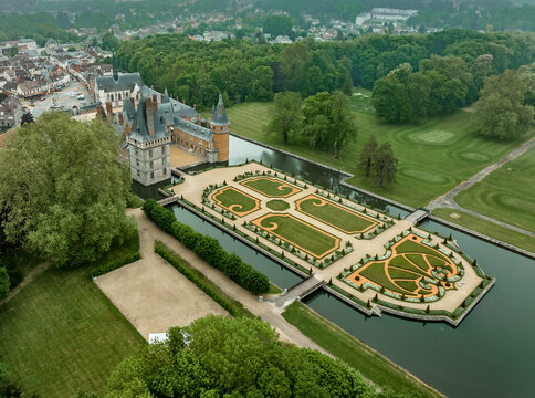 Aerial view of Maintenon castle, a French Renaissance chateau with magnificent manicured gardens and a lake in France